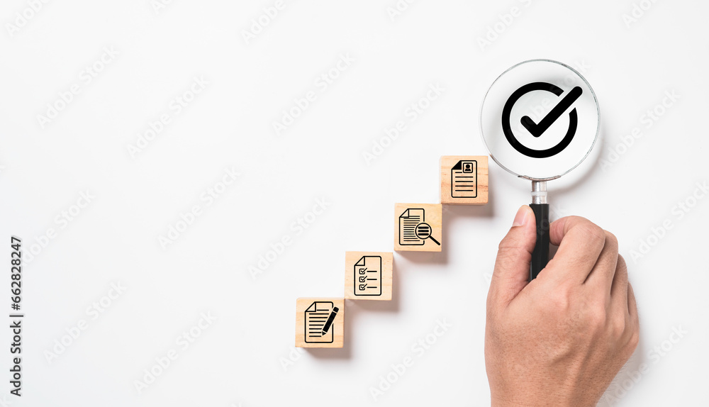 Aufkleber Hand holding magnifier glass with correct sign or tick mark and document for quality assurance , project approve and accept verification code concept.