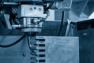 Closeup scene the wire EDM machine cutting the mold insert parts.