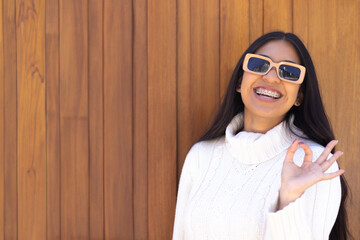 Native American young woman smiling making ok gesture. Copyspace.