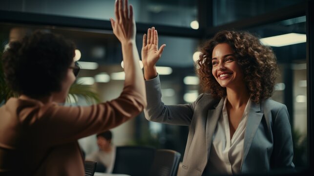 Successful Business People Giving Each Other High Five In A Meeting,colleagues Sharing Joy Of Achievement.happy Businesswomen Giving High Five Celebrating Business Success Together In Coworking Space