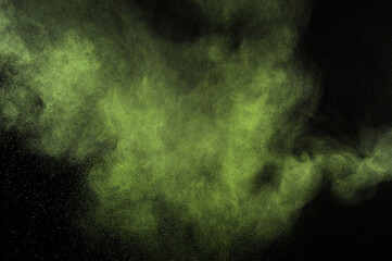 Light green powder explosion on black background. Citron color cloud. Lime dust explode. Freeze motion paint  Holi.