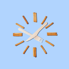 Clock with hands for a fork and knife, cookies in the form of numbers. The concept of waiting.