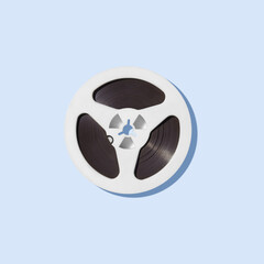 White reel for tape recorder isolated on blue background.
