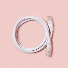 LAN white on a pink background. White ethernet cable on a pink background.