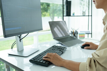 Fototapeta na wymiar Female IT programmer innovates at office desk.