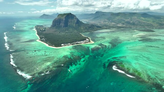 Aerial view of Mauritius island and Le Morne Brabant mountain with beautiful lagoon and underwater waterfall illusion