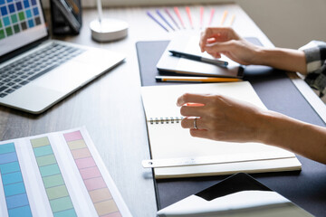 Young female architect envisions project at office desk.