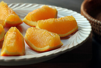 sliced ​​fresh ripe oranges in a white plate
