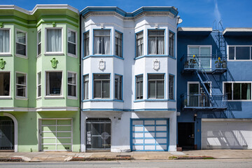 Blue and green residential buildings located on streets of San Francisco on sunny summer day
