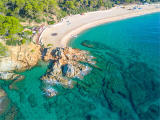 Fenals, Lloret de Mar Aerial view with Drone from the beach, Blue, turquoise, dense water, green vegetation, Mediterranean, transparent, nature, European quality tourism © Osvaldo Mussi