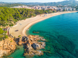 Fenals, Lloret de Mar Aerial view with Drone from the beach, Blue, turquoise, dense water, green vegetation, Mediterranean, transparent, nature, European quality tourism