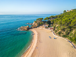 Fenals, Lloret de Mar Aerial view with Drone from the beach, Blue, turquoise, dense water, green vegetation, Mediterranean, transparent, nature, European quality tourism
