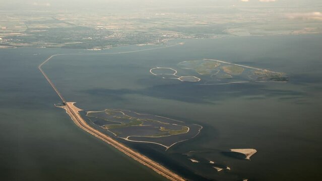 Aerial film, footage from the Marker Wadden, new manmade artificial islands with sandbanks and bird nature reserve, habitat, refuge, shelter along dike in The Netherlands, Europe