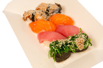 Sushi with salmon, eel, tuna, hiyashi wakame, sesame isolated.