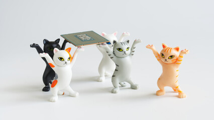Funny toy kittens with raised paws carry a modern powerful computer processor. Assembling,...