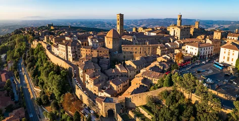 Fototapeten Italy. Volterra - scenic medieval town of Tuscany, Italian famous landmarks and heritage site. aerial drone panorama over sunset. © Freesurf