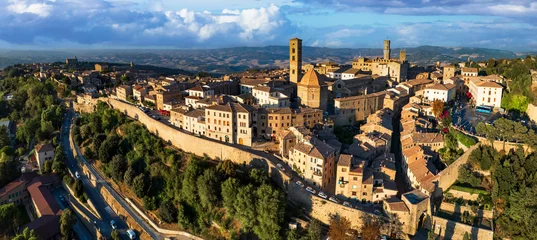 Poster Italy. Volterra - scenic medieval town of Tuscany, Italian famous landmarks and heritage site. aerial drone panorama over sunset. © Freesurf