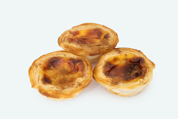 Pastel de nata or pastel de belem from Portugal. Three tart desserts on white background with a top view.