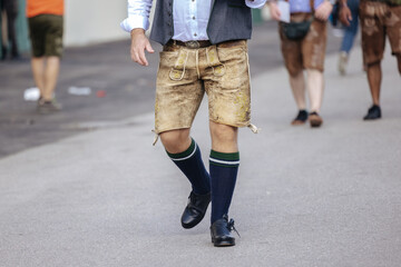 Man wearing the traditional Bavarian Lederhosen at the Oktoberfest in Munich close-up