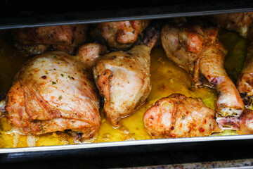 Chicken legs recipe. Cheap dinner idea background. Crunchy chicken skin. Lunch meat snack. Roasted chicken leg in oven. Fried meat. Grilled chicken. Group of meat pieces. Pile of food on tray.