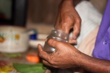 A man hold plastic pot and background blur