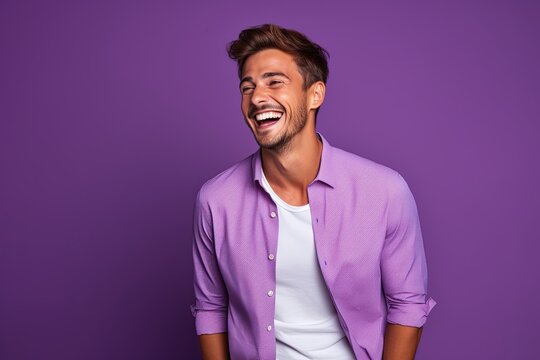 Handsome laughing caucasian man wearing purple clothes.