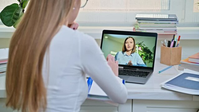 Teenage girl studying online, student having video call with teacher