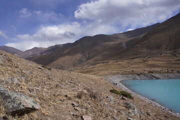 Fototapeta na wymiar turquoise lake in the mountains, mountains, sky, lake