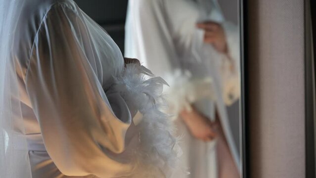 beautiful bride in a dressing gown is posing