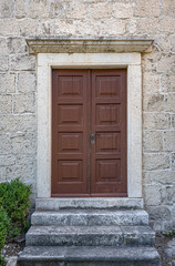 An antique wooden door on the facade of a building.