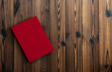 Red book on wooden table