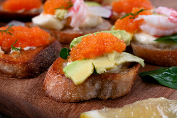 Bruschetta with caviar, avocado and cheese