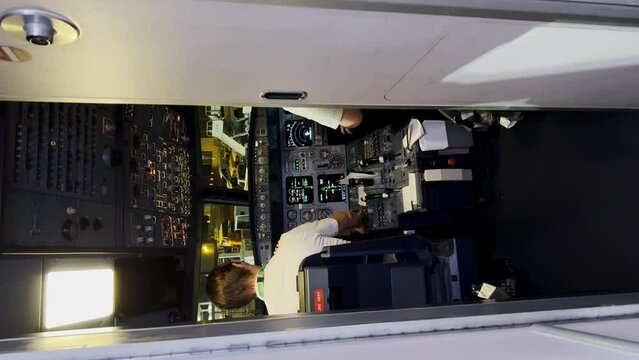 Vertical View from the cockpit of an airline operating a airplane a commercial pilot on a charter flight, two pilots board a plane, rear view. Chicago IL. USA 22 November 2022