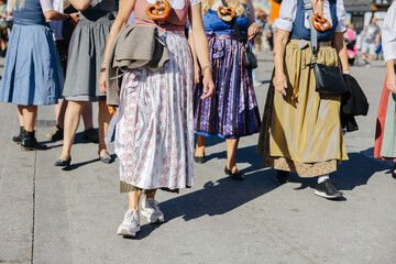 Fototapeta na wymiar Woman wearing the traditional Bavarian dress Dirndl at the Oktoberfest in Munich, Germany