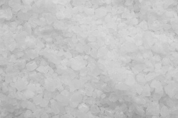 White sea salt as background, top view