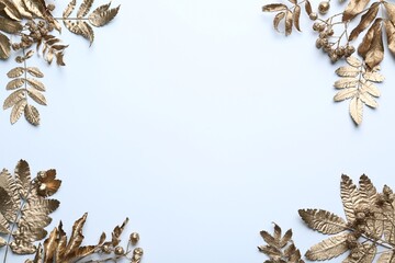 Frame made of golden rowan leaves and berries on white background, flat lay with space for text. Autumn season