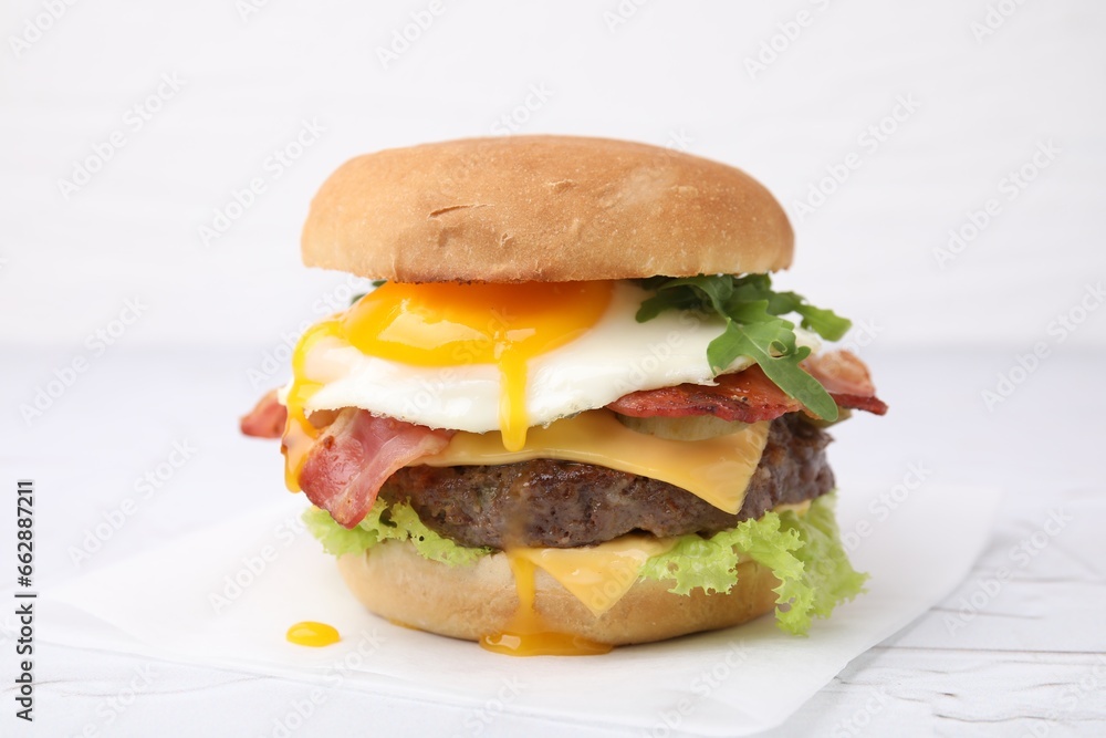 Wall mural delicious burger with fried egg on white table