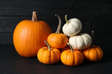 Thanksgiving day. Beautiful composition with pumpkins on black table