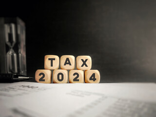Tax 2024 on wooden cubes. Tax-filling concept background.