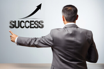 Back view of a businessman pointing to a white board with the word "Success" in capital letters and an upward arrow above it.  Concept of success in business, sales, profit and career.