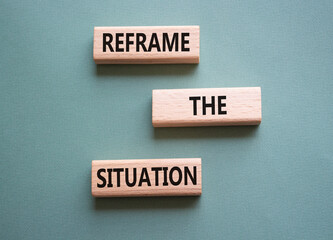 Reframe the situation symbol. Concept words Reframe the situation on wooden blocks. Beautiful grey...