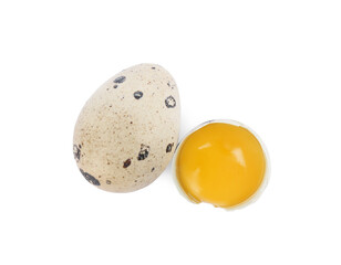 Whole and cracked quail eggs on white background, top view