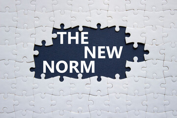 The new norm symbol. Concept words The new norm on white puzzle. Beautiful dark blue background. Business and The new norm concept. Copy space. - obrazy, fototapety, plakaty