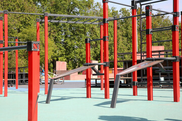 Empty outdoor gym with exercise equipment in park