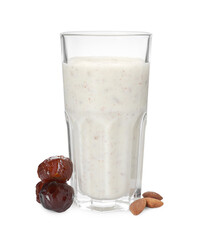 Glass of delicious date smoothie, dried fruits and nuts on white background