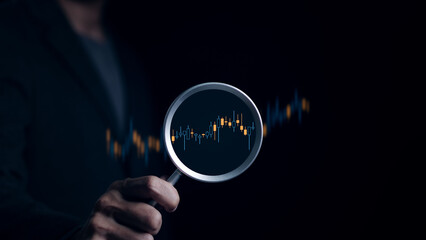 Stock investment concept. Businessman hand holding magnifying glass with virtual stock market chart, Currency exchange trade, Graph analysis technical, Business growth, Economic report, Money wealth,