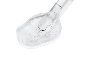 Dripping cosmetic oil from pipette onto light surface, closeup