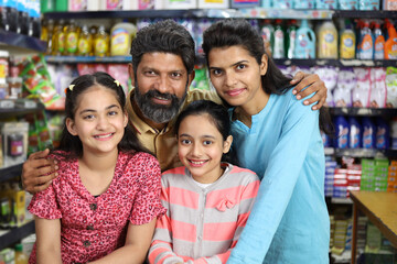 happy family shopping in grocery store and supermarket. They are looking for desired products they need to purchase.