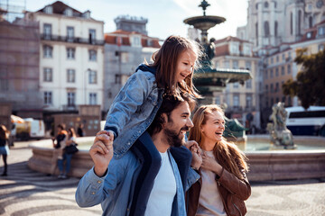 Young tourist family walking and exploring the Rossio in Lisbon