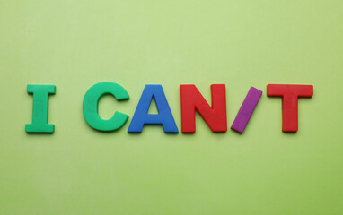 Motivation concept. Changing phrase from I Can't into I Can by adding slash symbol on light green background, flat lay